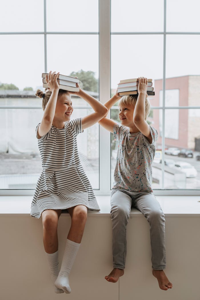 creative-03 Two happy children playing with books, embodying the joy of learning together.